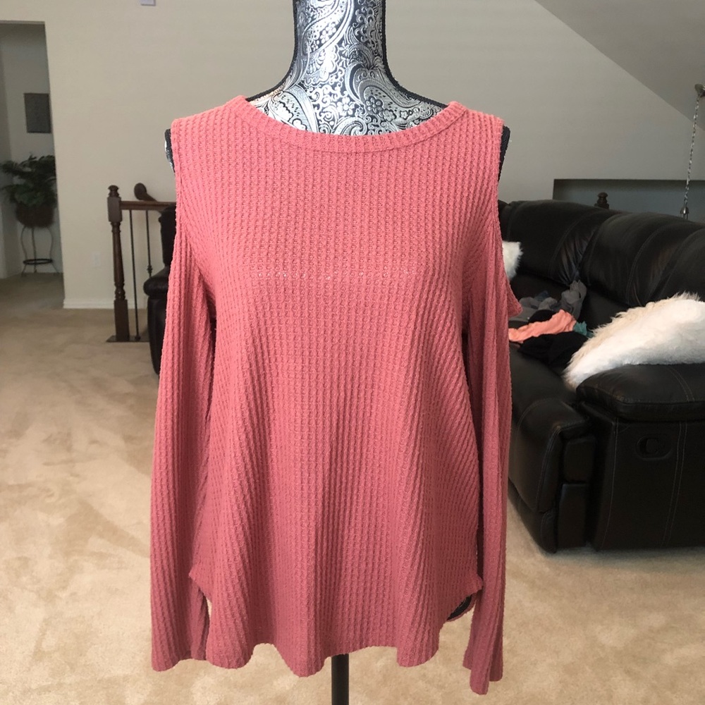 A soft, pink sweater that’s been worn once.
